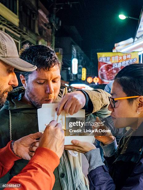 friends eating with chopsticks asian night market - taiwan night market stock pictures, royalty-free photos & images