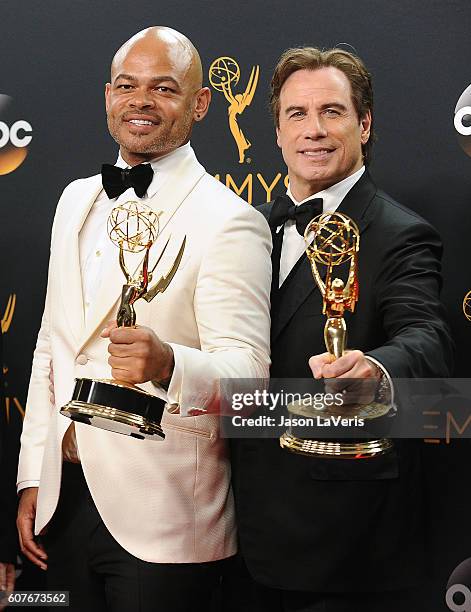 Director Anthony Hemingway and producer John Travolta pose in the press room at the 68th annual Primetime Emmy Awards at Microsoft Theater on...