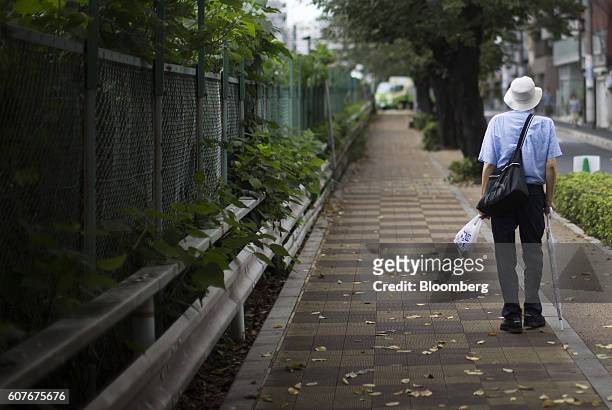 Man walks on a road in the Sugamo district of Tokyo, Japan, on Monday, Sept. 15, 2016. The proportion of Japans aged has been rising steadily for...