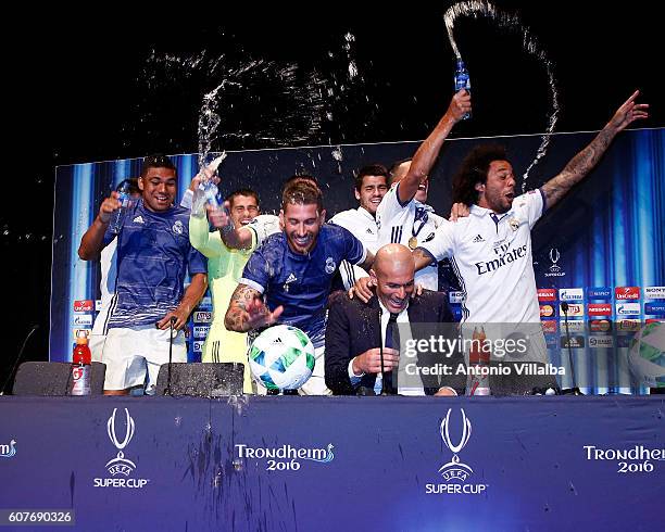 Real Madrid players celebrate with coach Zinedine Zidane in the press conference after the UEFA Super Cup match between Real Madrid and Sevilla at...