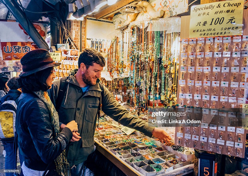 Mixed race couple shopping open air Asian Market