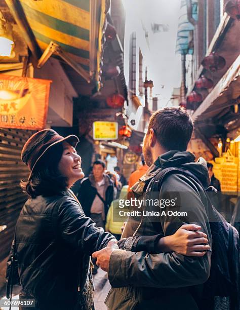 mixed race couple shopping open air asian market - taipei market stock pictures, royalty-free photos & images