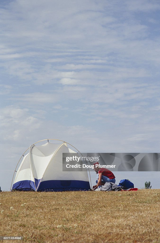 Woman Putting up Tent