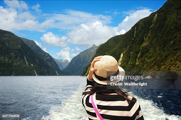 young woman on ship on milford sound cruise. - new zealand v china stock pictures, royalty-free photos & images