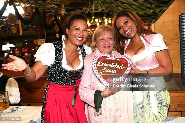 Patricia Blanco, her mother Mireille Blanco and her sister Mercedes Blanco pose during the Oktoberfest at Augustiner-Braeu at Theresienwiese on...