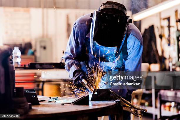 senior man welding in workshop - in flames i the mask stock pictures, royalty-free photos & images