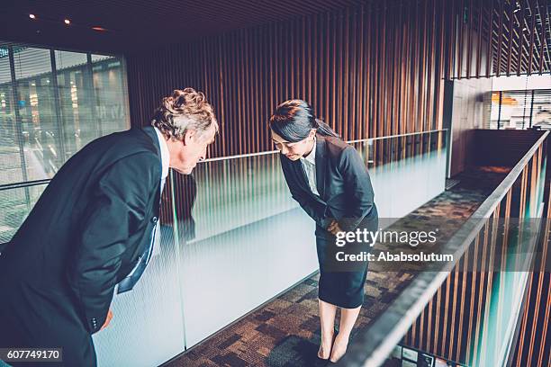 senior caucasian businessman and young japanese entrepreneur bowing, kyoto, japan - woman bowing stock pictures, royalty-free photos & images
