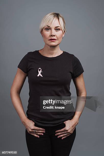 Woman with pink ribbon breast cancer awareness symbol
