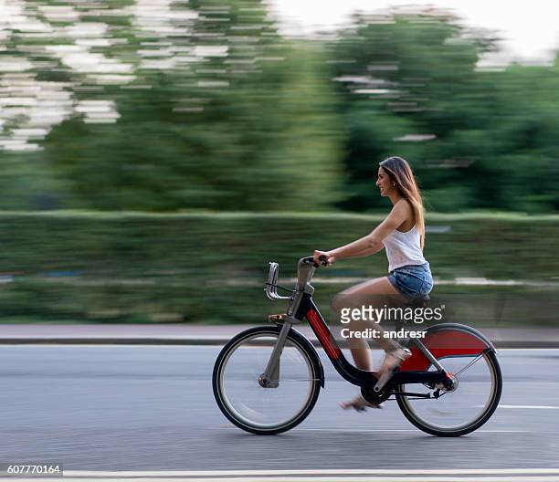 woman riding a bike - london bikes stock pictures, royalty-free photos & images
