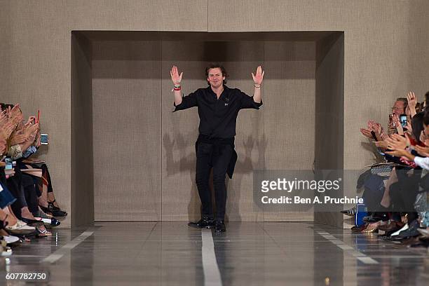 Christopher Kane waves to the audience at the end of the Christopher Kane runway show during London Fashion Week Spring/Summer collections 2017 on...
