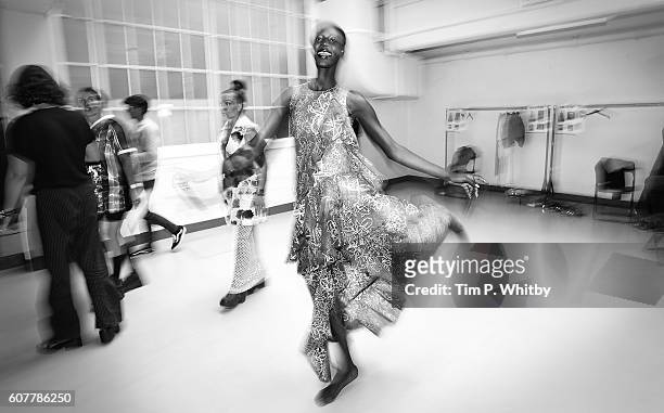 Model skips across the floor backstage ahead of the Fyodor Golan presentation during London Fashion Week Spring/Summer collections 2017 at The Vinyl...