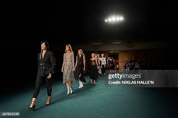 Models present creations by Osman during the 2017 Spring / Summer catwalk show at London Fashion Week in London on September 19, 2016. / AFP / Niklas...