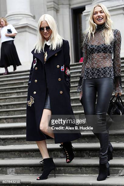 Poppy Delevingne and Jessica Hart attend the Christopher Kane show at Tate Britain during London Fashion week on September 19, 2016 in London,...