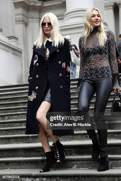 Poppy Delevingne and Jessica Hart attend the Christopher Kane show at Tate Britain during London Fashion week on September 19, 2016 in London,...