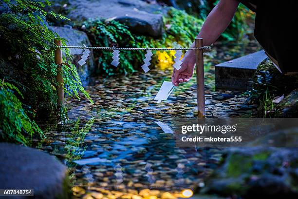 floating human shape paper - shinto shrine stock pictures, royalty-free photos & images