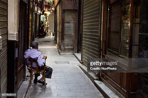 An Egyptian vendor waits for customers in his shop in Khan Al-Khalili market in Cairo, Egypt,on September 19, 2016. Shops are not working because of...