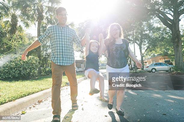 young family walking in winter park neighborhood orlando florida - orlando florida stock pictures, royalty-free photos & images