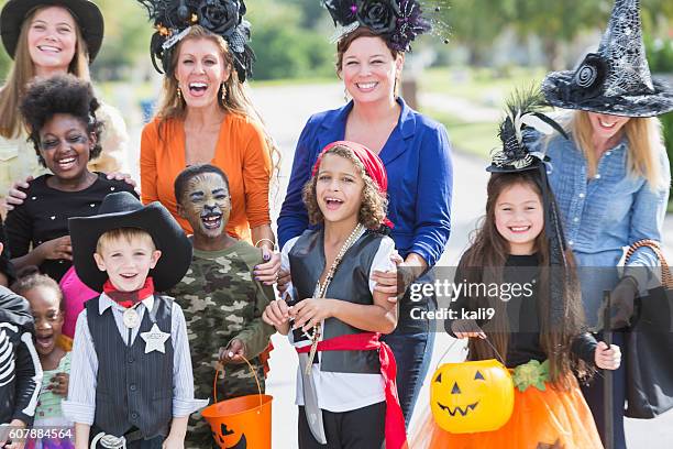 group of children and mothers on halloween - princess pirates stock pictures, royalty-free photos & images