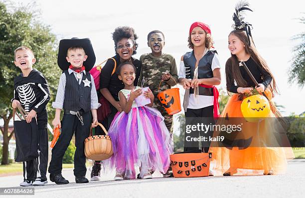 multi-ethnic group of children in halloween costumes - bus eller godis bildbanksfoton och bilder