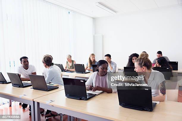 training class students learning at pc discussion - showing laptop stock pictures, royalty-free photos & images