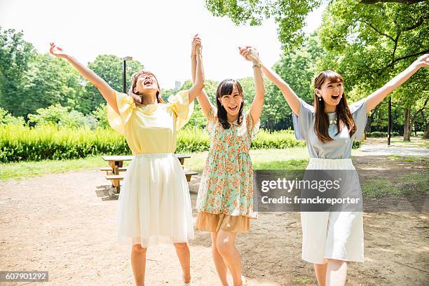 japanese friends playing togetherness on the park - candid beautiful young woman face stock pictures, royalty-free photos & images