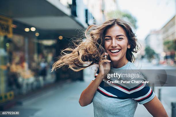 turning around to look back - beautiful woman in the city imagens e fotografias de stock