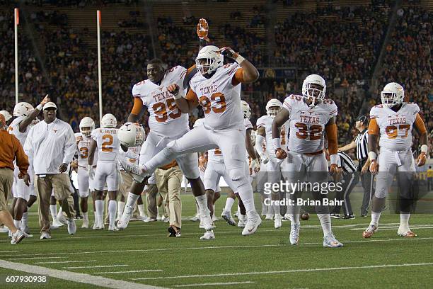 Defensive tackle Paul Boyette Jr. #93 and defensive tackle Poona Ford of the Texas Longhorns celebrate stopping the California Golden Bears on fourth...