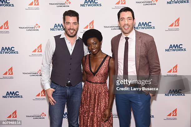 Jonathan Scott, actress Danai Gurira and Drew Scott pose for a photo during the WICT Leadership Conference Touchstones Luncheon at Marriot Marquis on...