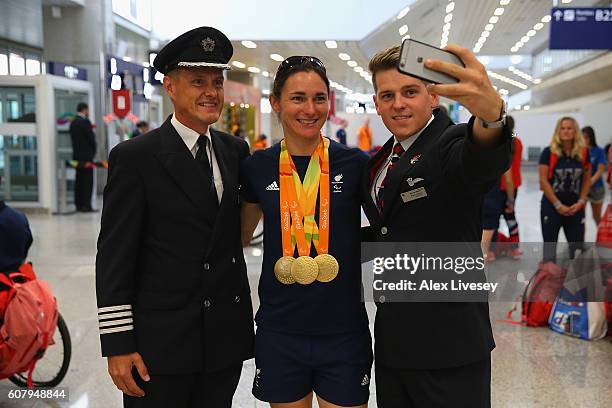 Sarah Storey of the Paralympics GB Team has a selfie taken with members of the British Airways crew as they prepare to fly back from Galeao Airport...