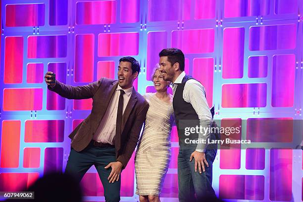 The Property Brothers Drew Scott and Jonathan Scott take a selfie with Chief Programming, Content & Brand Officer for Scripps Networks Interactive...