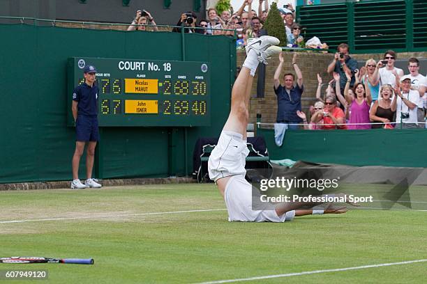 John Isner of the USA celebrates winning his first round match against Nicolas Mahut of France on Day Four of the Wimbledon Lawn Tennis Championships...