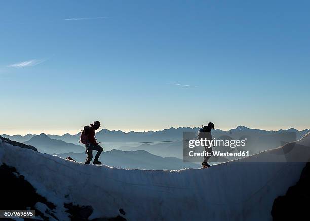 france, ecrins alps, two mountaineers at dauphine - climbing snow mountain imagens e fotografias de stock