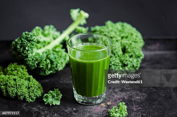 glass of kale smoothie with different fruits - kale stock pictures, royalty-free photos & images