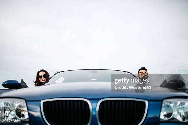 young couple taking the heads of their car - front view of car stock pictures, royalty-free photos & images