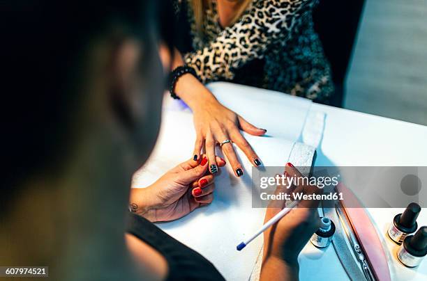 nail grooming in beauty salon - nail salon stock pictures, royalty-free photos & images