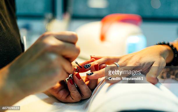 nail grooming in beauty salon - fingernägel lackieren stock-fotos und bilder