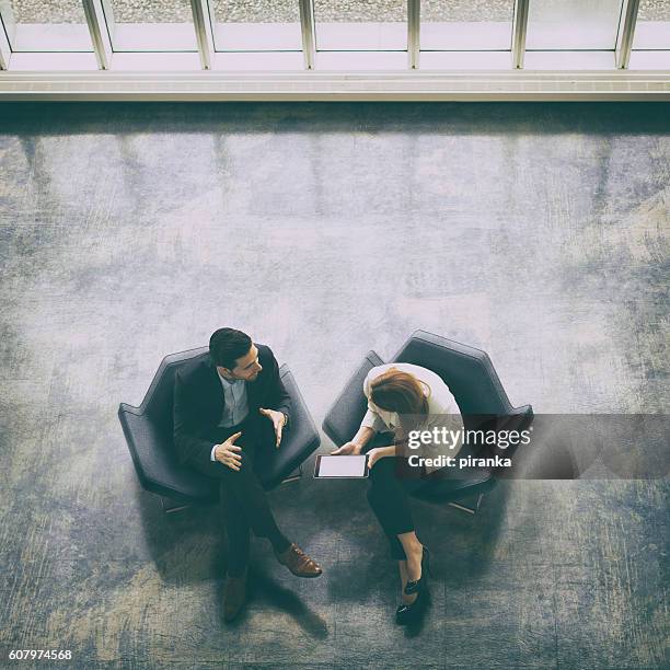 overhead view of two business persons in the lobby - lounge chair bildbanksfoton och bilder