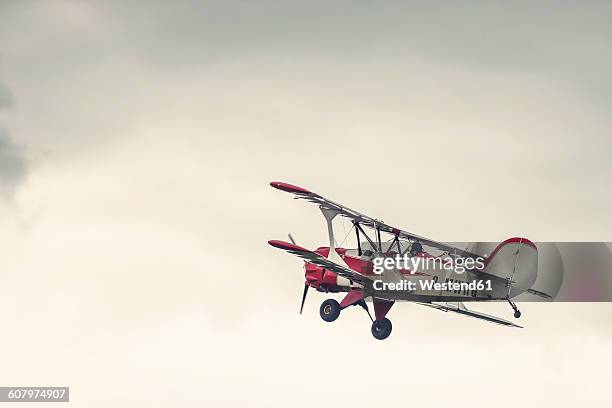 germany, dierdorf, vintage biplane in the air - propellervliegtuig stockfoto's en -beelden