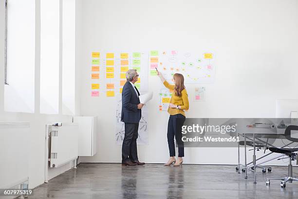 businessman and coworker in office discussing orgchart - organisation chart stock pictures, royalty-free photos & images