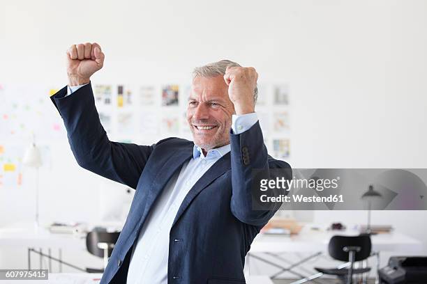 businessman cheering in office - business people cheering in office stock-fotos und bilder
