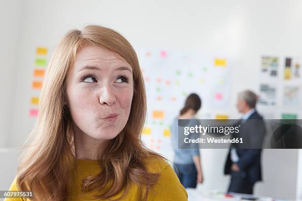 young woman in office thinking - suspicion office stock pictures, royalty-free photos & images