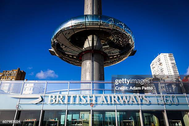 people walking outside british airways i360 tower in brighton, uk - british airways plane stock pictures, royalty-free photos & images