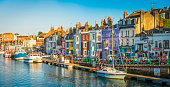 Colourful fishing cottages seaside harbour resort tourists pubs panorama Dorset