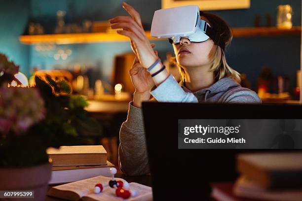 woman using a virtual reality headset. - vr imagens e fotografias de stock