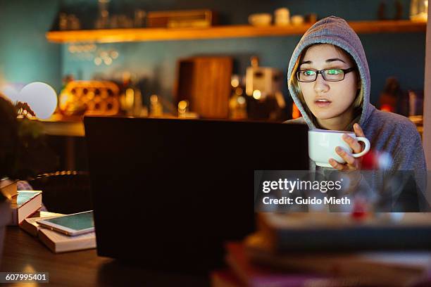 woman watching a movie at night. - film lighting equipment stock pictures, royalty-free photos & images