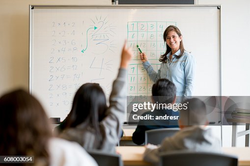Student asking a question in class Student asking a question in class
