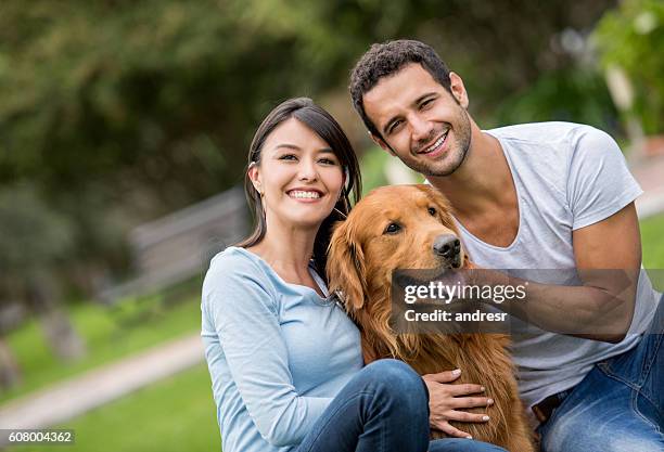 happy couple with their dog - retriever stock pictures, royalty-free photos & images