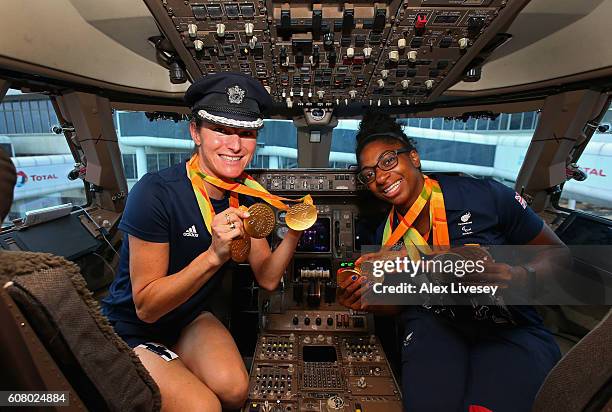 Sarah Storey and Kadeena Cox of the Paralympics GB Team shows her medals in the flight deck they prepare to fly back from Galeao Airport on British...