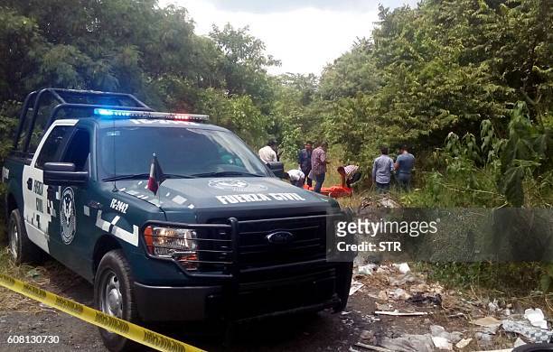 Forensic personnel and policemen recover the corpses of catholics priests Alejo Nabor Jimenez Juarez and Jose Alfredo Juarez de la Cruz who were...