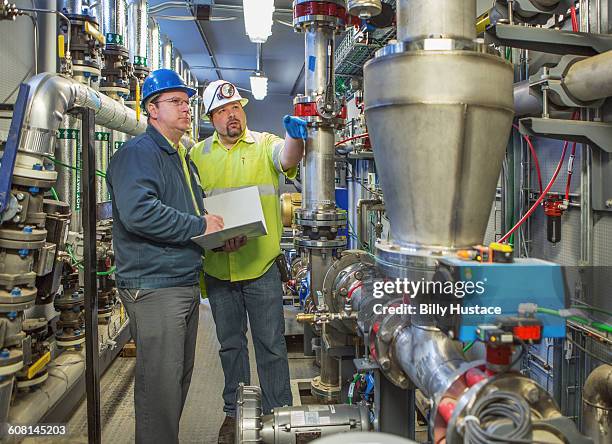 worker inspecting a solid waste processing plant - biogas stock pictures, royalty-free photos & images